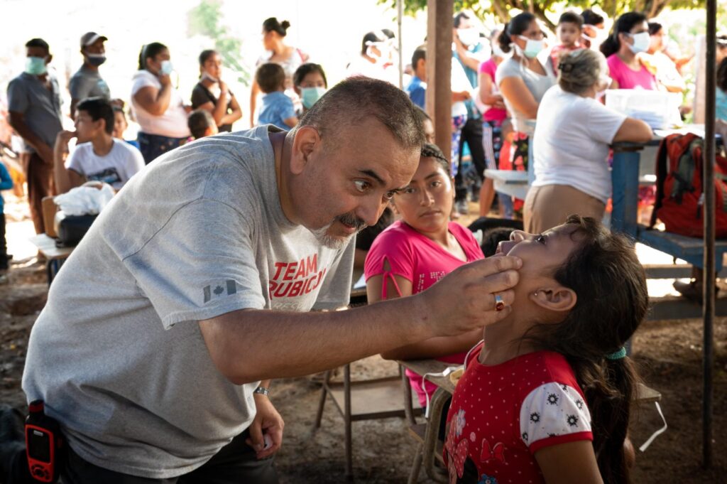Man looks in boy's mouth