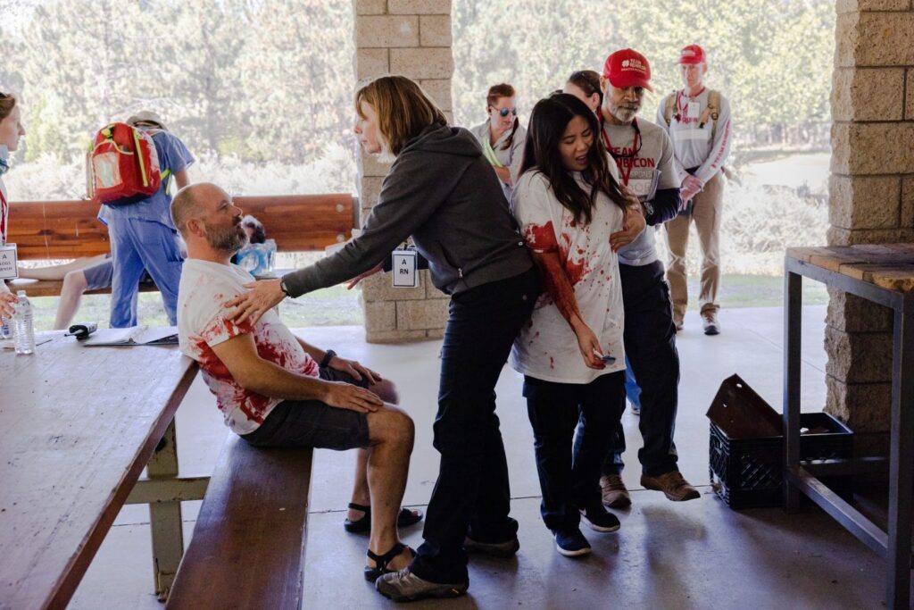 Actors pretending to be injured covered in fake blood.