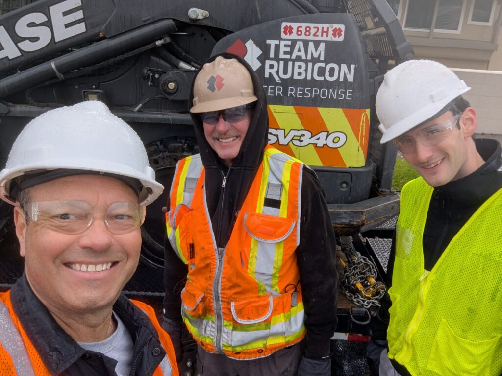 California wildfires volunteers in front of heavy equipment.