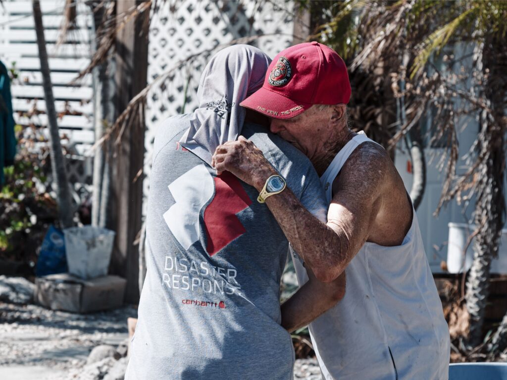 disaster survivor hugs author of article "Why Americans volunteer"